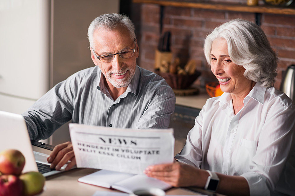 Senior couple viewing the newspaper